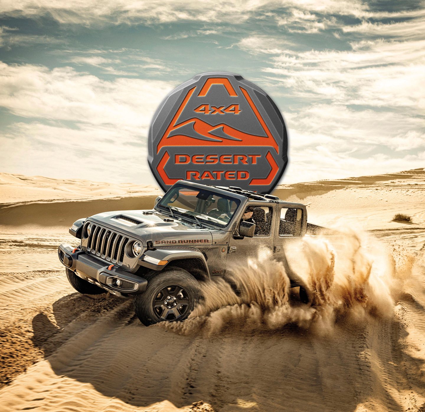 Trail Rated 4x4. The 2022 Jeep Gladiator Rubicon being driven on rocky terrain with one wheel elevated as it climbs a boulder.